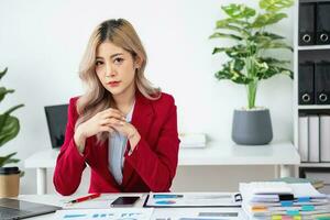 planning, auditing, business planning, finance, young asian business woman working on computer and checking investment documents and planning marketing to increase profit, business concepts photo