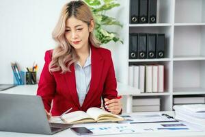 planning, auditing, business planning, finance, young asian business woman working on computer and checking investment documents and planning marketing to increase profit, business concepts photo