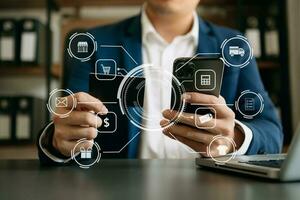 Close up of Hand using credit card and smartphone, laptop computer on wooden desk with VR icon chart graph diagram photo