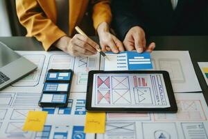 UX graphic designer planning application process development prototype wireframe for web smart phone. Creative digital development agency. photo