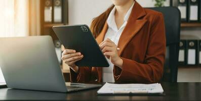 Confident businessw0man working on laptop,tablet and smartphone at her workplace at modern office. photo