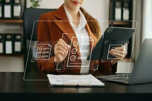 E-document management Paperless workplace, e-signing, electronic signature, document management. businessman signs an electronic document on a virtual notebook screen using a stylus pencil. photo