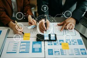 Close up view of UI developer team brainstorming on their project with laptop, smartphone and digital tablet. Creative digital development agency. with virtual icons photo
