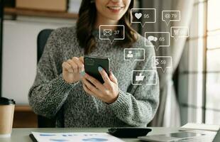 Social media and Marketing virtual icons screen concept.close up of businesswoman typing keyboard tablet with laptop computer  and smart phone photo