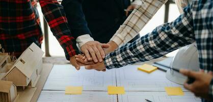 Engineer and contractor join hands after signing contract,They are having a modern building project together. successful cooperation concept photo