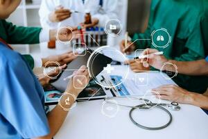 Medical technology network team meeting concept. Doctor hand working with smart phone modern digital tablet and laptop computer with graphics chart interface, with virtual icon diagram photo