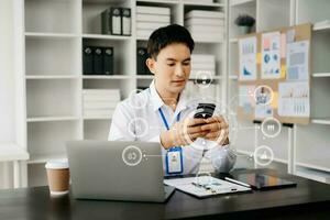 Businessman working with laptop computer and smart phone on desk in office with virtual icon diagram photo