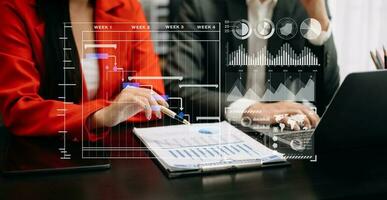 Business team hand Project manager working and update tasks and Gantt chart scheduling virtual diagram.with smart phone, tablet and laptop photo
