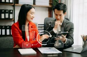 Business Asian team partnership meeting concept. Business hand using laptop, tablet and smartphone  in office. Digital marketing media mobile app in virtual icon screen photo