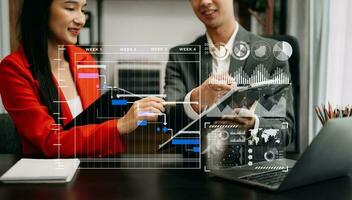 Business team hand Project manager working and update tasks and Gantt chart scheduling virtual diagram.with smart phone, tablet and laptop photo