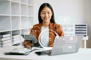 close up of businesswoman working with laptop computer and smart phone on desk in modern office with virtual icon diagram photo