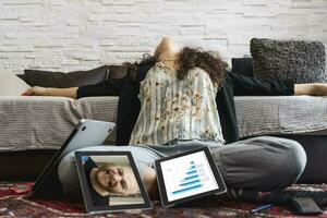 young woman takes a relaxing moment working at home on computer during restrictions due to covid-19 photo