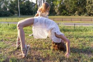 cute little girl is doing artistic gymnastics exercises photo