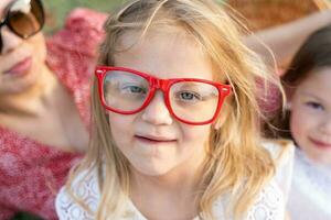 funny portrait of little baby girl wearing vintage colored glasses photo