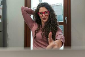 young woman is working at home on the computer during the restrictions due to the covid-19 photo