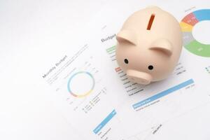 Piggy bank with business graph on white background and copy space, financial goal concept. Business concept. photo