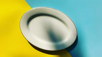 empty plate on a blue and yellow background photo