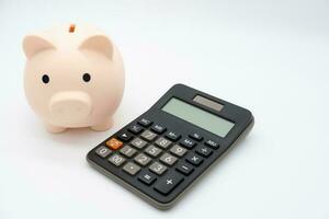 Piggy bank with Calculator on isolated background. Saving money and financial management. photo