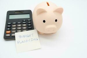 Piggy bank with Calculator on isolated background. Saving money and financial management. photo