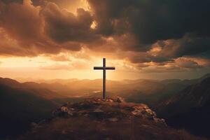 Cross on the top of the mountain with sunset background. photo