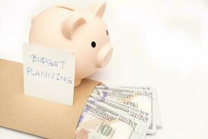 Money budget planning. Piggy bank with calculator and notebooks on white background, financial goal concept. photo