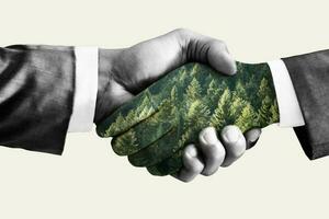 Green deal concept, handshake. Double exposure, hands with forest. photo