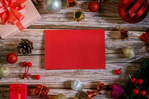 Christmas composition on a wood background and a blank red card for writing the text. Layout Christmas background concept photo