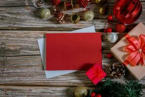 Christmas composition on a wood background and a blank red card for writing the text. Layout Christmas background concept photo