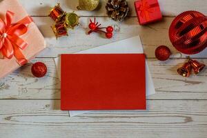 Christmas composition on a white wood background and a blank red card for writing the text. Layout Christmas background concept photo