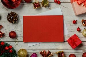 Navidad composición en un blanco madera antecedentes y un blanco rojo tarjeta para escritura el texto. diseño Navidad antecedentes concepto foto