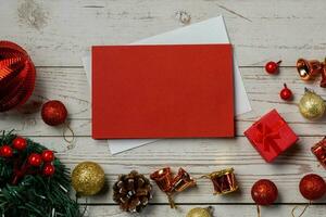 Christmas composition on a white wood background and a blank red card for writing the text. Layout Christmas background concept photo