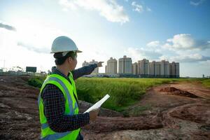 Engineer male working or checking at construction building site photo