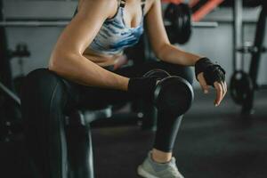 Shot of asian women lifting dumbbells at the gym, Concept of exercise girl photo