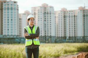 Engineer male working or checking at construction building site photo