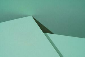Colorful background from green paper with shadow. Abstract geometric photo