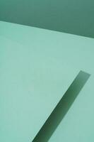 Colorful background from green paper with shadow. Abstract geometric photo