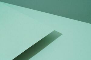 Colorful background from green paper with shadow. Abstract geometric photo