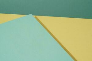 Colorful background from green and yellow paper with shadow. Abstract geometric photo