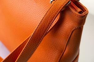 Close-up of a fashionable orange women's handbag on white background photo