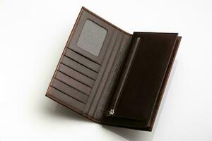 Close-up shot of a fashionable leather men's wallet on a white background with reflection photo