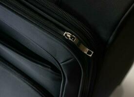 Close-up of black suitcase zipper photo