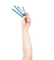 Man's arm raised holding a office supplies pens. Isolate on white background. photo