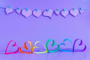 Love hearts with the colors of LGBT on blue background. photo