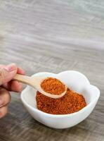 Close up of wooden spoon with red pepper. photo