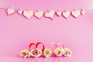 Love hearts and roses on pink background. photo