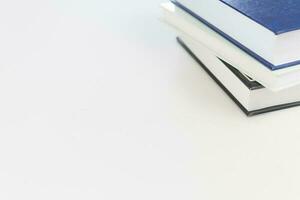 Desk with stack of study books. Textbooks for the student, university. Study from home. Distance education concept. photo