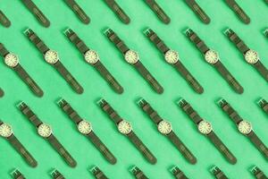 Top view of pattern green sports watch, on green pastel background. Isolated watch, banner. photo