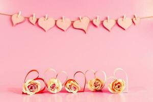 Love hearts and roses on pink background. photo