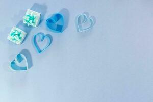 Love hearts and gifts on blue background. photo