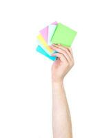 Man's arm raised holding a office supplies. Isolate on white background. photo